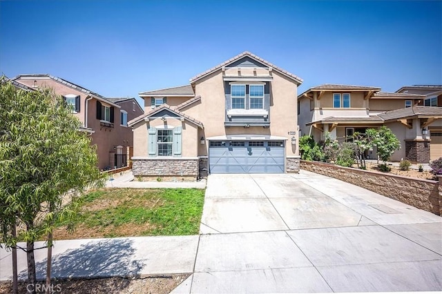 5240 Wintercress Ave, Fontana, CA 92336 - view of front of house with stucco siding, concrete driveway, stone siding, a tile roof, and a garage
