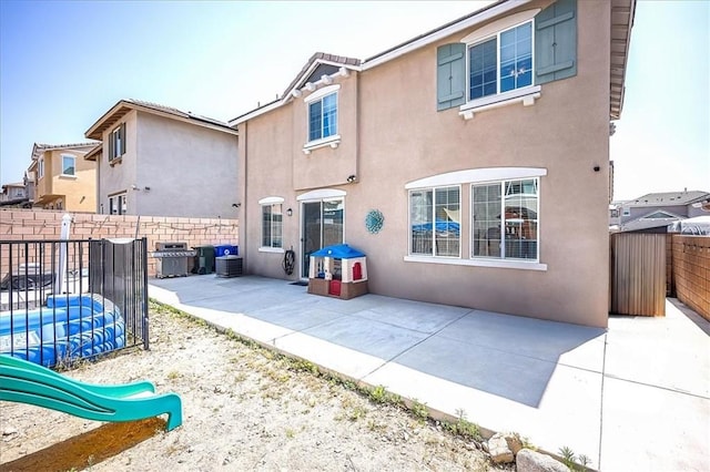 5240 Wintercress Ave, Fontana, CA 92336 - back of property featuring a patio area, stucco siding, a fenced backyard, and a playground