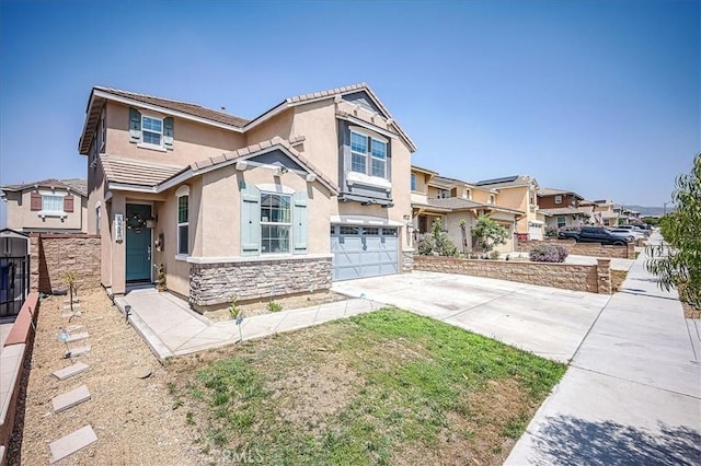5240 Wintercress Ave, Fontana, CA 92336 - view of front of home with stucco siding, driveway, stone siding, a garage, and a tiled roof