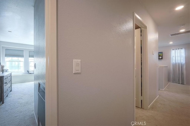 5240 Wintercress Ave, Fontana, CA 92336 - hallway with light colored carpet, healthy amount of natural light, a textured wall, and recessed lighting