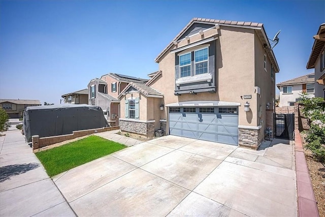 5240 Wintercress Ave, Fontana, CA 92336 - view of front of home with stucco siding, stone siding, a garage, and driveway
