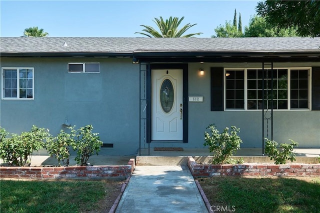 512 Maple St, Willows, CA 95988 - doorway to property with roof with shingles and stucco siding
