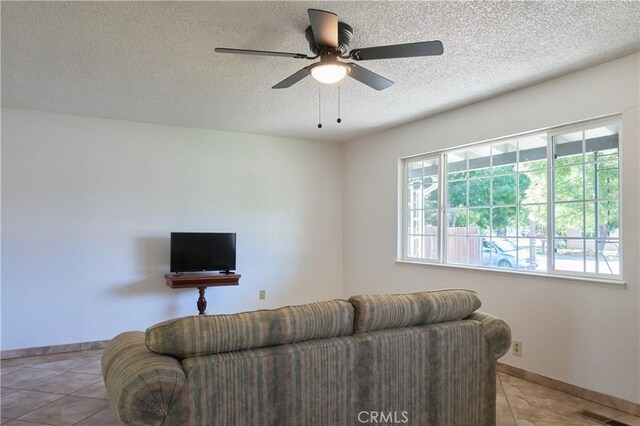 512 Maple St, Willows, CA 95988 - tiled living room featuring a textured ceiling, ceiling fan, and baseboards