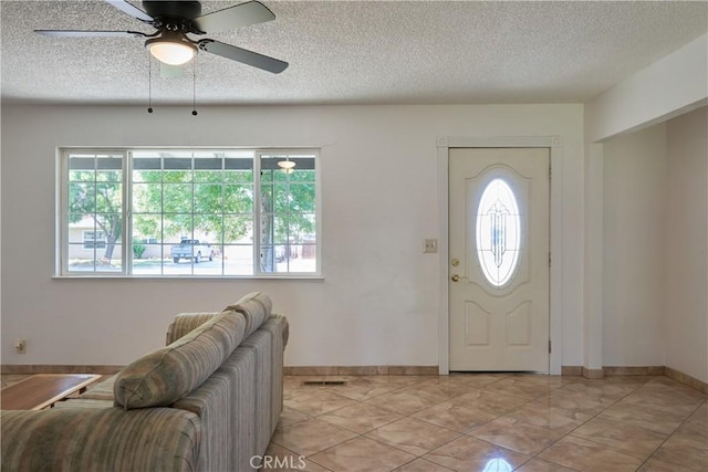 512 Maple St, Willows, CA 95988 - entrance foyer featuring a textured ceiling, a ceiling fan, baseboards, and light tile patterned floors