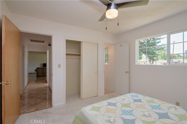 512 Maple St, Willows, CA 95988 - bedroom with a closet, a textured ceiling, a ceiling fan, and light carpet