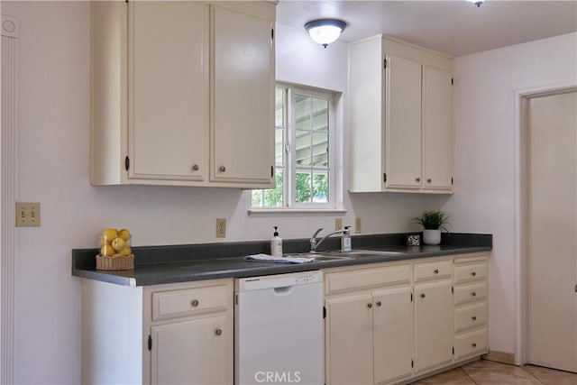 512 Maple St, Willows, CA 95988 - kitchen with white dishwasher, dark countertops, a sink, light tile patterned floors, and white cabinetry