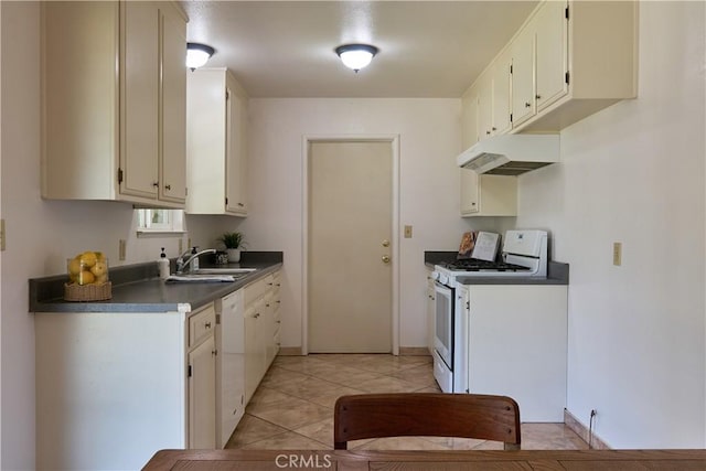 512 Maple St, Willows, CA 95988 - kitchen featuring white appliances, under cabinet range hood, a sink, dark countertops, and light tile patterned floors