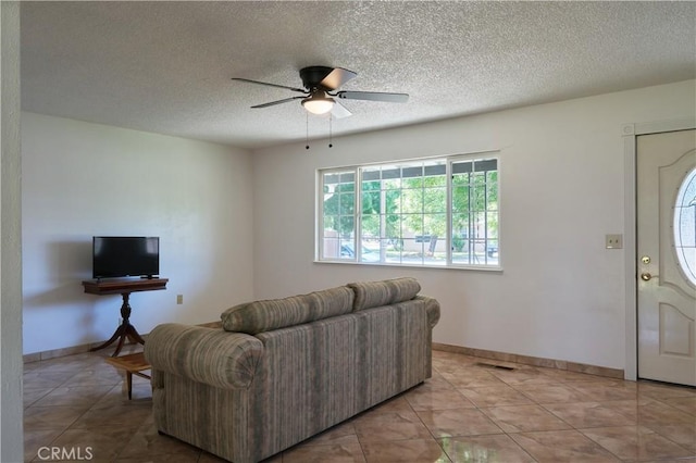 512 Maple St, Willows, CA 95988 - living area with ceiling fan, a textured ceiling, light tile patterned flooring, and baseboards