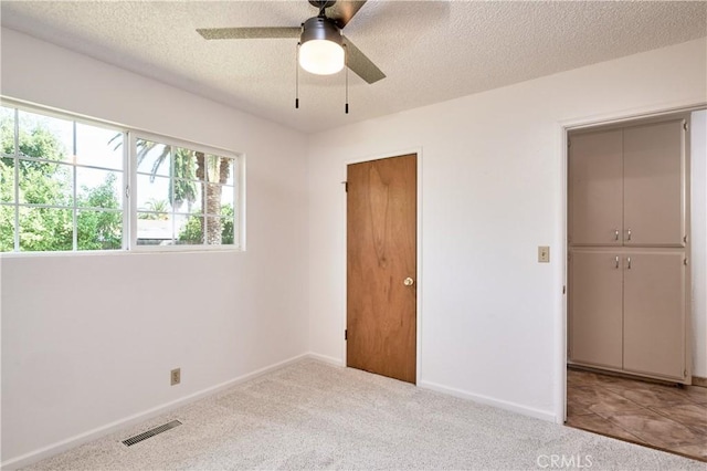 512 Maple St, Willows, CA 95988 - unfurnished bedroom with a textured ceiling, baseboards, carpet flooring, and ceiling fan