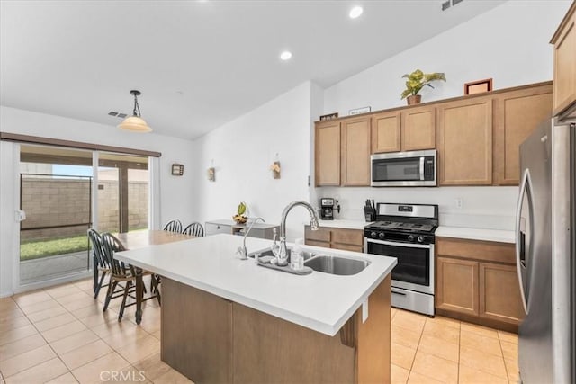 1331 Nicholas Ct, Rialto, CA 92377 - kitchen featuring appliances with stainless steel finishes, a sink, light tile patterned floors, light countertops, and brown cabinetry
