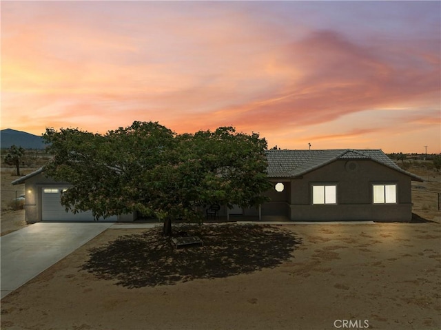 13044 Smith Rd, Phelan, CA 92371 - view of front of property with driveway, a tile roof, solar panels, and stucco siding