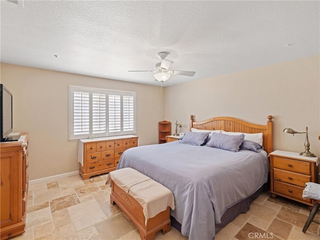 13044 Smith Rd, Phelan, CA 92371 - bedroom featuring stone tile floors, a ceiling fan, and a textured ceiling