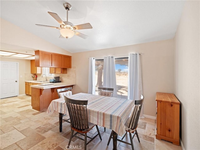 13044 Smith Rd, Phelan, CA 92371 - dining area featuring lofted ceiling, ceiling fan, stone tile floors, and baseboards