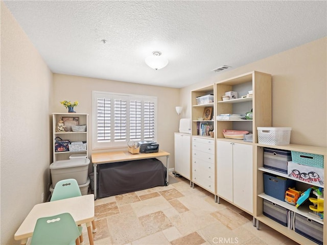 13044 Smith Rd, Phelan, CA 92371 - office space featuring a textured ceiling and light stone finish flooring