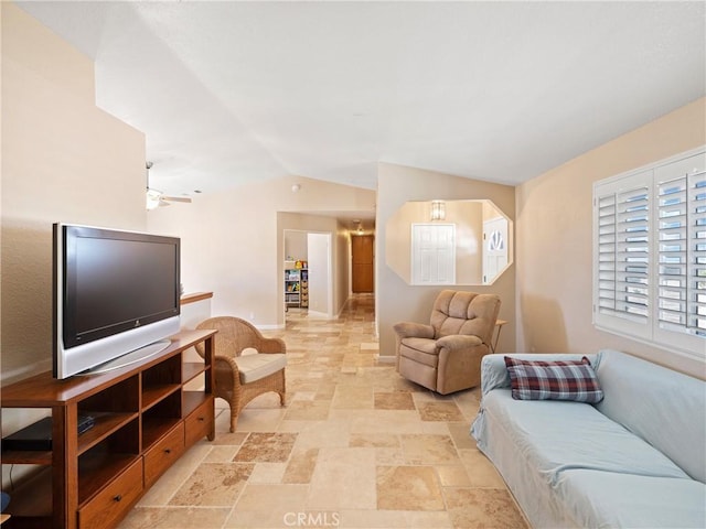 13044 Smith Rd, Phelan, CA 92371 - living room featuring vaulted ceiling, stone tile floors, and baseboards