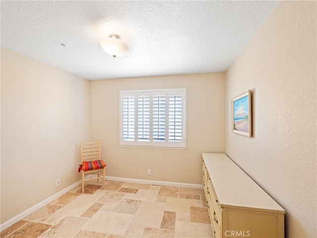 13044 Smith Rd, Phelan, CA 92371 - unfurnished room with light stone finish floors, baseboards, and a textured ceiling