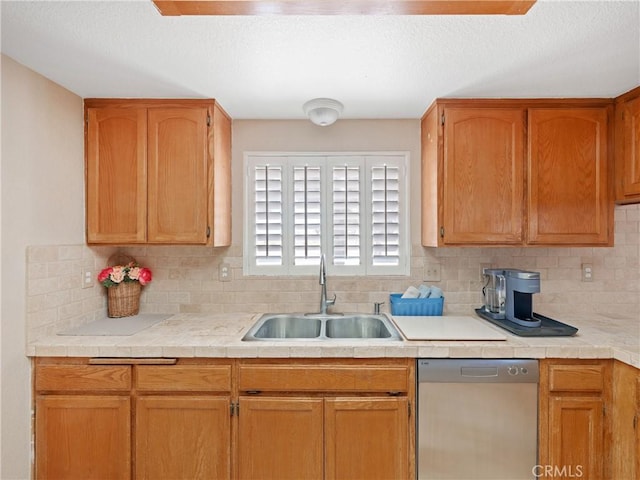 13044 Smith Rd, Phelan, CA 92371 - kitchen with stainless steel dishwasher, a sink, decorative backsplash, light countertops, and a textured ceiling