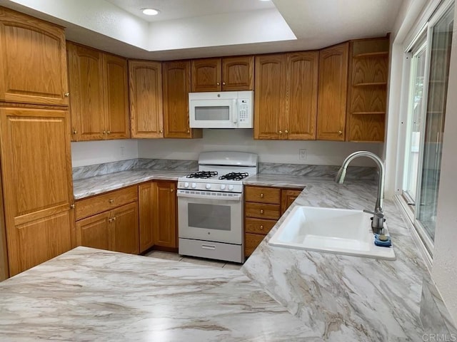 3465 Spanish Way, Carlsbad, CA 92008 - kitchen featuring white appliances, a sink, brown cabinets, open shelves, and light stone counters