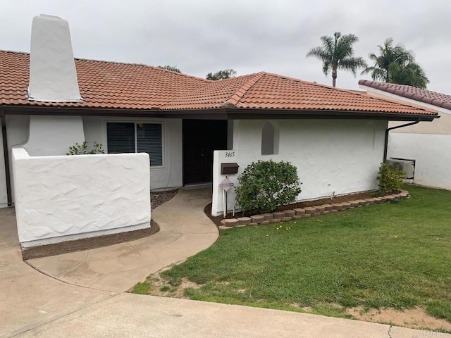 3465 Spanish Way, Carlsbad, CA 92008 - view of front of home with a tile roof, a front yard, stucco siding, and a chimney