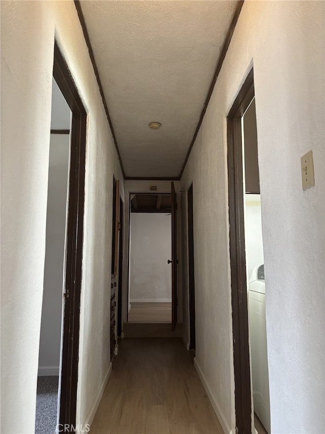 919 Dexter St, Los Angeles, CA 90042 - hall featuring light wood finished floors, a textured wall, and baseboards