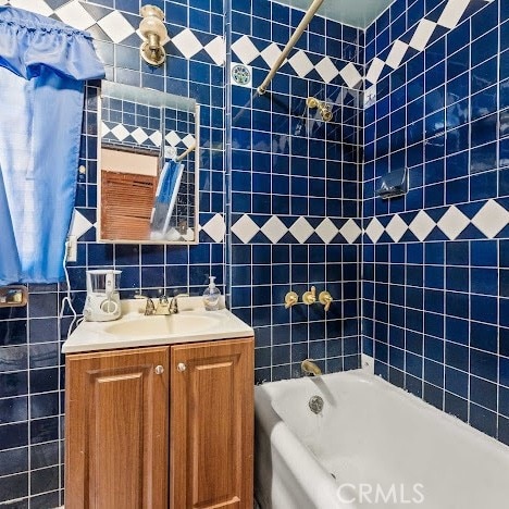 919 Dexter St, Los Angeles, CA 90042 - bathroom with  shower combination, vanity, and tile walls