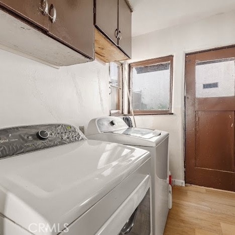 919 Dexter St, Los Angeles, CA 90042 - laundry room with washing machine and dryer, cabinet space, and light wood-style floors