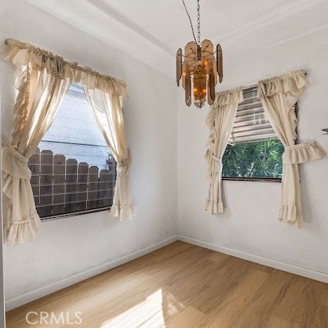 919 Dexter St, Los Angeles, CA 90042 - spare room featuring wood finished floors and a chandelier
