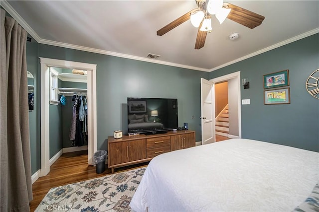 536 W Palm Dr, Arcadia, CA 91007 - bedroom with wood finished floors, crown molding, a walk in closet, a ceiling fan, and a closet