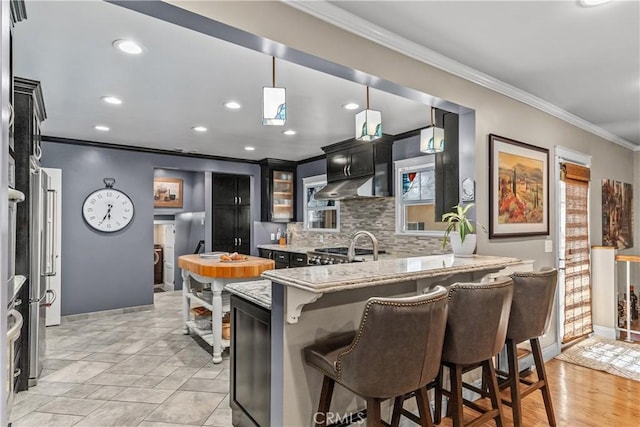 536 W Palm Dr, Arcadia, CA 91007 - kitchen with crown molding, a breakfast bar area, tasteful backsplash, under cabinet range hood, and baseboards