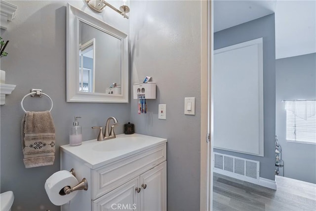 140 W 220th St Unit 105, Carson, CA 90745 - bathroom with wood finished floors, vanity, and toilet