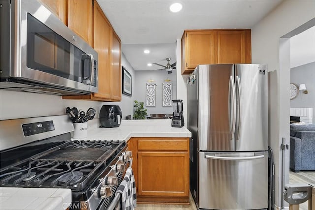 140 W 220th St Unit 105, Carson, CA 90745 - kitchen featuring stainless steel appliances, recessed lighting, a ceiling fan, tile countertops, and brown cabinetry