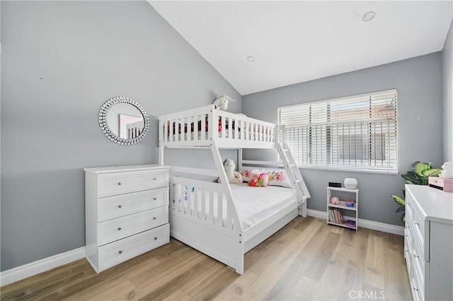 140 W 220th St Unit 105, Carson, CA 90745 - bedroom with light wood-style flooring, baseboards, and lofted ceiling
