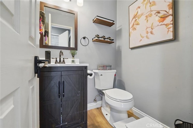 140 W 220th St Unit 105, Carson, CA 90745 - half bath with toilet, wood finished floors, vanity, and baseboards