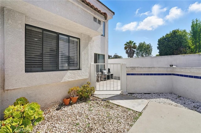 140 W 220th St Unit 105, Carson, CA 90745 - view of home's exterior with stucco siding and a gate