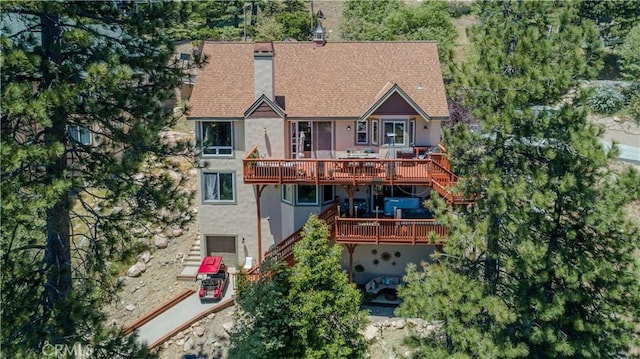 781 Brentwood Dr, Lake Arrowhead, CA 92352 - back of property with a deck, stucco siding, stairs, and roof with shingles