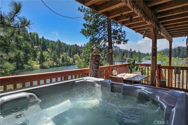 781 Brentwood Dr, Lake Arrowhead, CA 92352 - deck with a hot tub, a wooded view, and a water view