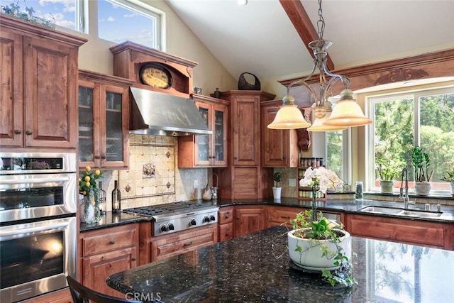 781 Brentwood Dr, Lake Arrowhead, CA 92352 - kitchen featuring appliances with stainless steel finishes, wall chimney range hood, lofted ceiling, backsplash, and healthy amount of natural light