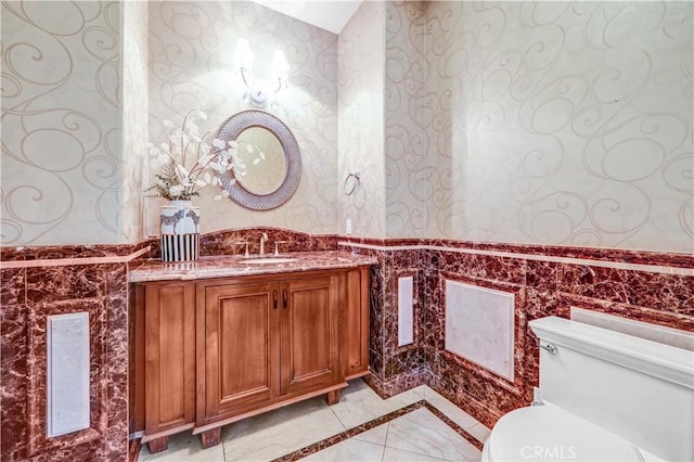 443 W Longden Ave, Arcadia, CA 91007 - bathroom with wallpapered walls, inlaid floor details, a wainscoted wall, toilet, and vanity