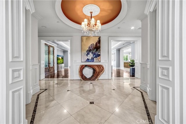 443 W Longden Ave, Arcadia, CA 91007 - hall with inlaid floor details, a chandelier, a raised ceiling, crown molding, and a decorative wall