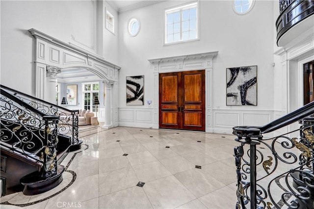 443 W Longden Ave, Arcadia, CA 91007 - foyer entrance with a decorative wall, a towering ceiling, stairs, ornate columns, and ornamental molding