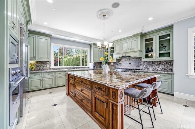 443 W Longden Ave, Arcadia, CA 91007 - kitchen with crown molding, a breakfast bar area, a kitchen island, a chandelier, and tasteful backsplash