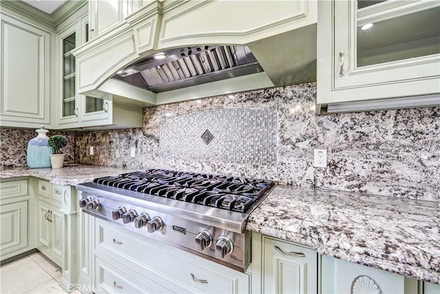 443 W Longden Ave, Arcadia, CA 91007 - kitchen with stainless steel gas cooktop, custom exhaust hood, glass insert cabinets, light stone counters, and tasteful backsplash