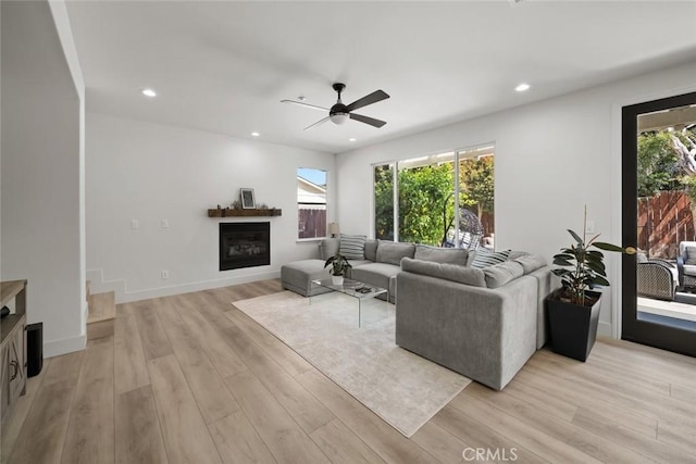 1941 Devaul Ranch Dr, San Luis Obispo, CA 93405 - living area featuring a glass covered fireplace, a ceiling fan, light wood finished floors, recessed lighting, and baseboards