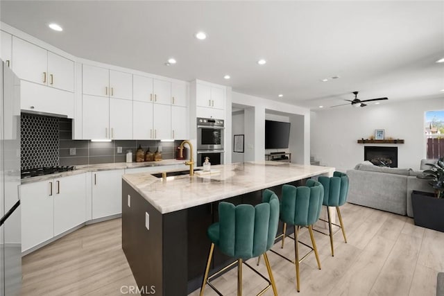 1941 Devaul Ranch Dr, San Luis Obispo, CA 93405 - kitchen with a sink, ceiling fan, light wood-style floors, decorative backsplash, and recessed lighting