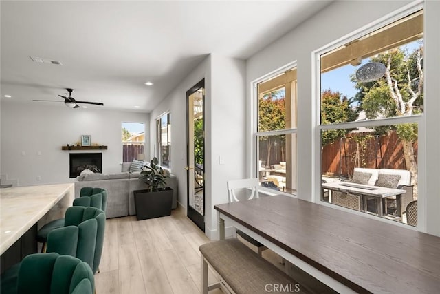 1941 Devaul Ranch Dr, San Luis Obispo, CA 93405 - dining room with healthy amount of natural light, light wood-style flooring, ceiling fan, recessed lighting, and a fireplace