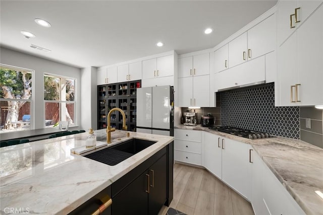 1941 Devaul Ranch Dr, San Luis Obispo, CA 93405 - kitchen featuring black gas stovetop, freestanding refrigerator, a sink, recessed lighting, and decorative backsplash