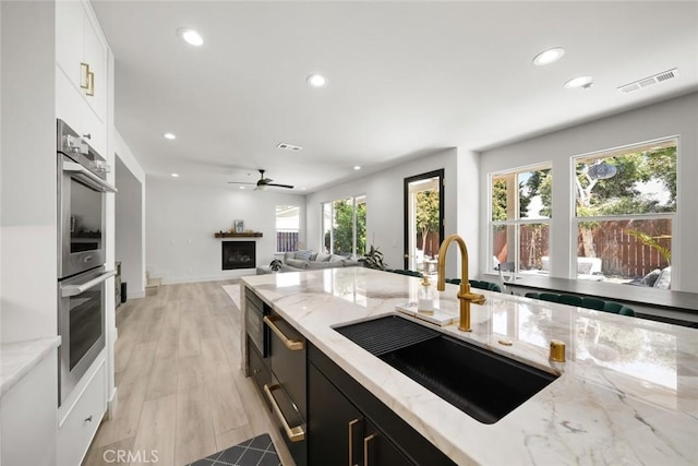 1941 Devaul Ranch Dr, San Luis Obispo, CA 93405 - kitchen with a sink, recessed lighting, double oven, dark cabinets, and white cabinets