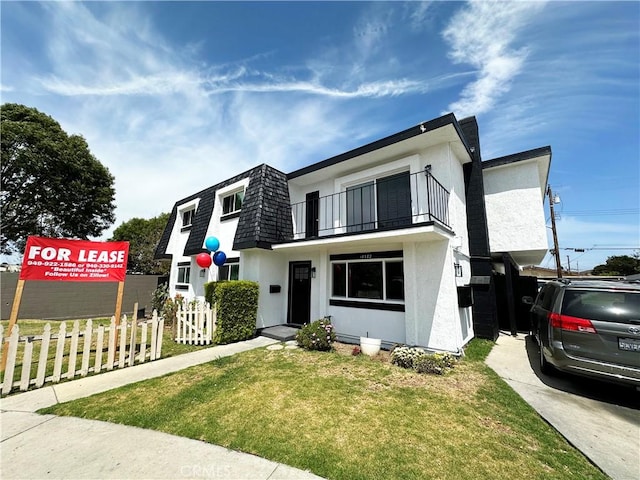 17372 Dairyview Cir, Huntington Beach, CA 92647 - view of front of home featuring a balcony, stucco siding, and mansard roof