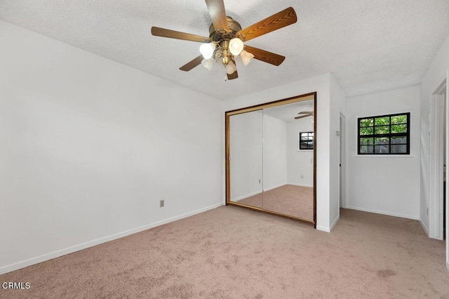 1139 Fairview Dr, La Canada Flintridge, CA 91011 - unfurnished bedroom featuring light colored carpet, a textured ceiling, a closet, baseboards, and a ceiling fan