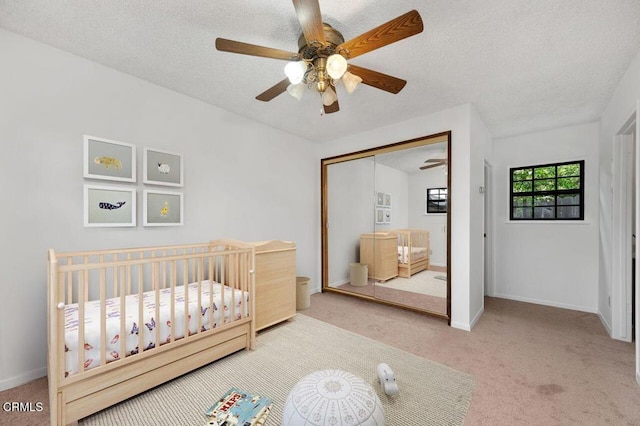 1139 Fairview Dr, La Canada Flintridge, CA 91011 - bedroom featuring carpet floors, a closet, a nursery area, a textured ceiling, and a ceiling fan